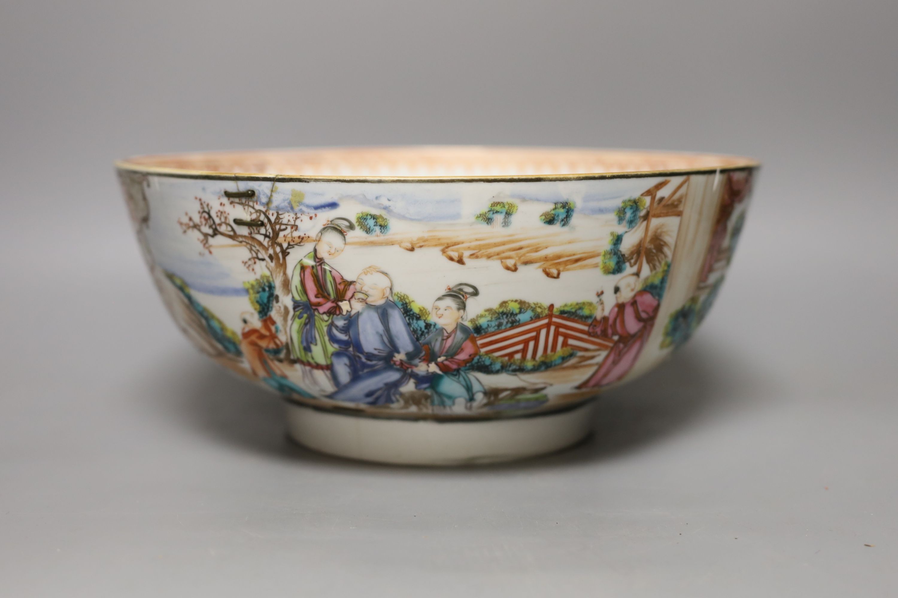 An 18th century Chinese export famille rose punch bowl (with historic damage and riveted repair) 28cm diameter